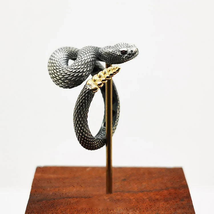 Adjustable snake ring with unique rattlesnake design in various color options, including white and black with open or shut mouth styles, and gold accents