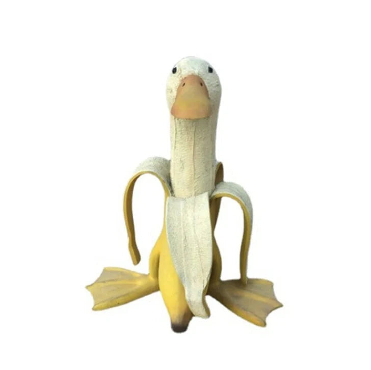 Banana Duck resin garden statue with vibrant yellow color and cartoon design
