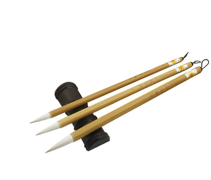 Three traditional Chinese writing brushes with woolen bristles and bamboo handles in large, medium, small sizes