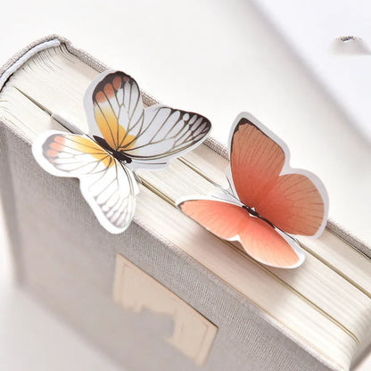 Decorative butterfly-shaped paper bookmark with colourful design, measuring 13.5cm by 5.5cm.