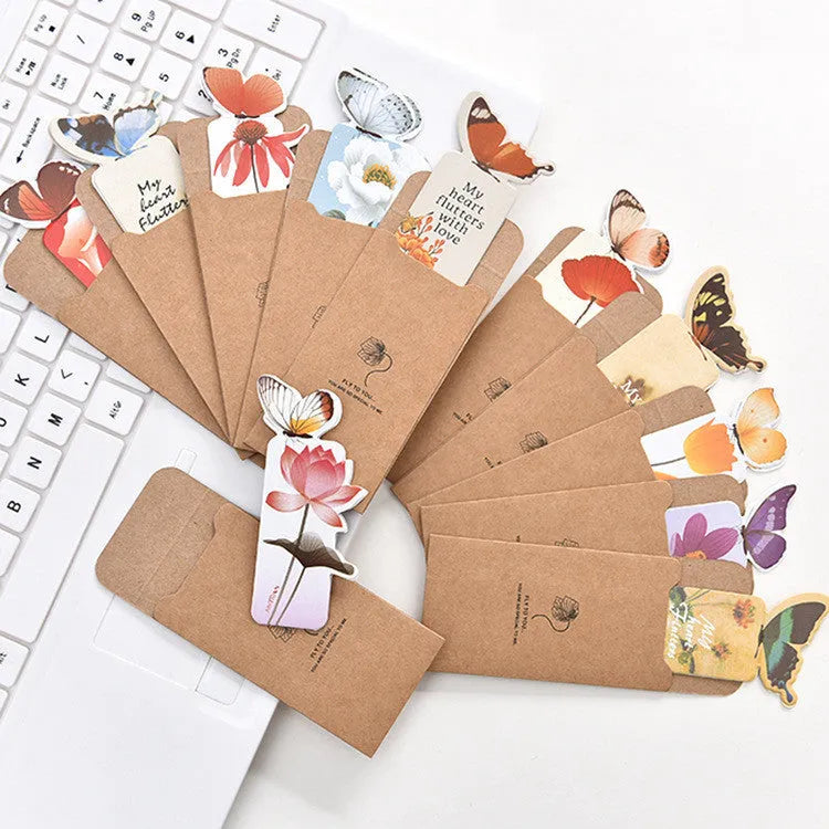 Decorative butterfly-shaped paper bookmark with colourful design, measuring 13.5cm by 5.5cm.