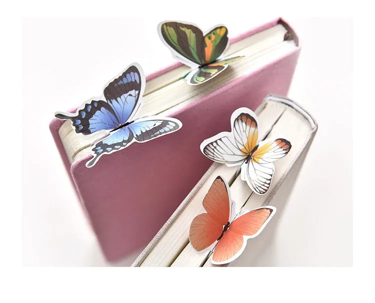 Decorative butterfly-shaped paper bookmark with colourful design, measuring 13.5cm by 5.5cm.