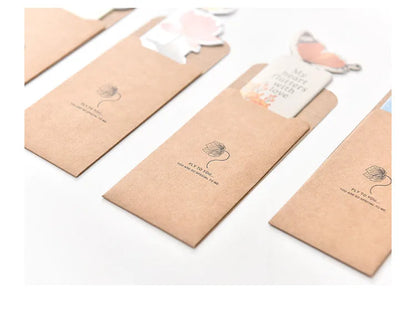 Decorative butterfly-shaped paper bookmark with colourful design, measuring 13.5cm by 5.5cm.