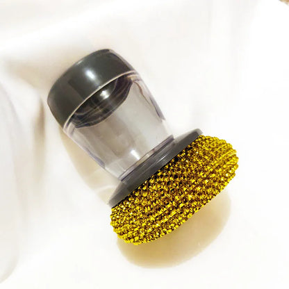Black and gold kitchen palm brush with soap dispenser for scrubbing stoves and tiles