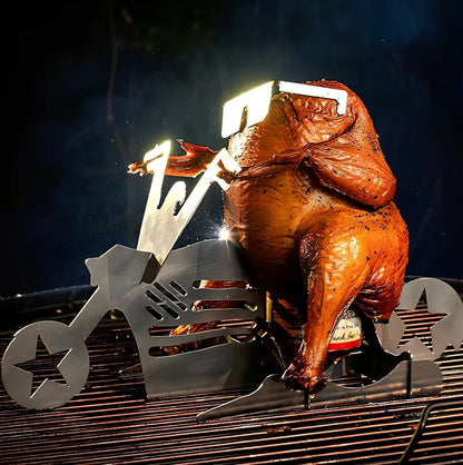 Steel motorcycle-shaped chicken roasting rack holding upright chicken with beer can on barbecue grill