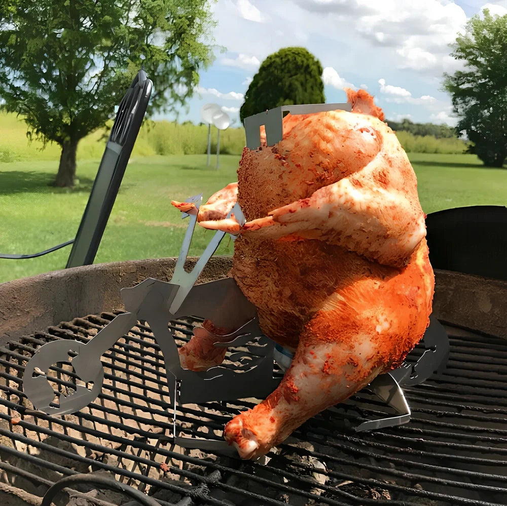 Steel motorcycle-shaped chicken roasting rack holding upright chicken with beer can on barbecue grill