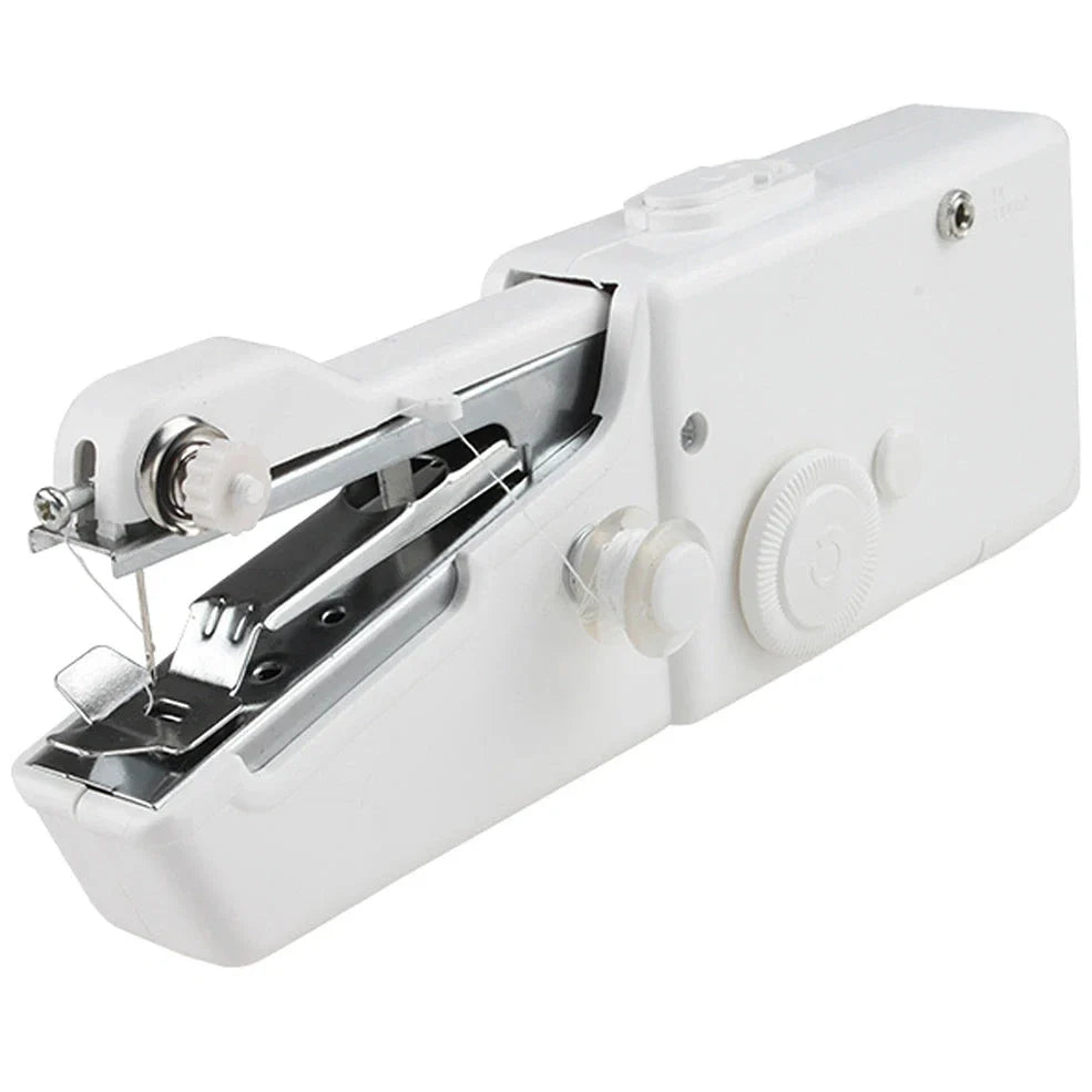 Black handheld electric sewing machine with ruler, scissors, and thread coils on white background