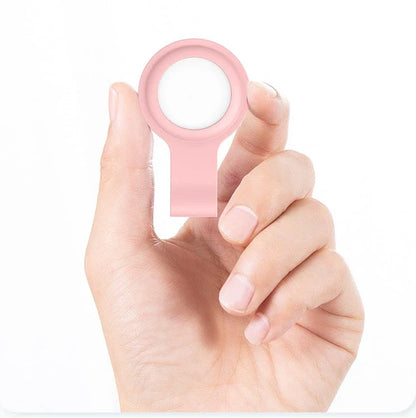 Soft, silicone AirTag holder in black and pink colors, providing protection and personalization for Apple tracking devices