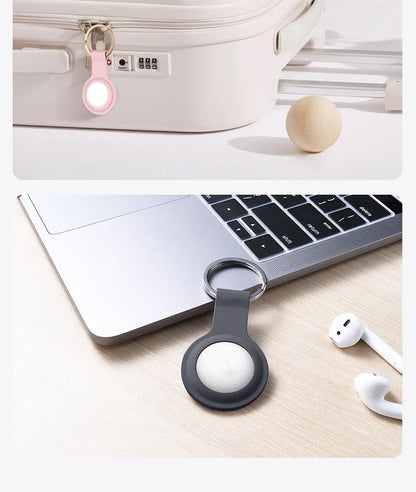 Soft, silicone AirTag holder in black and pink colors, providing protection and personalization for Apple tracking devices