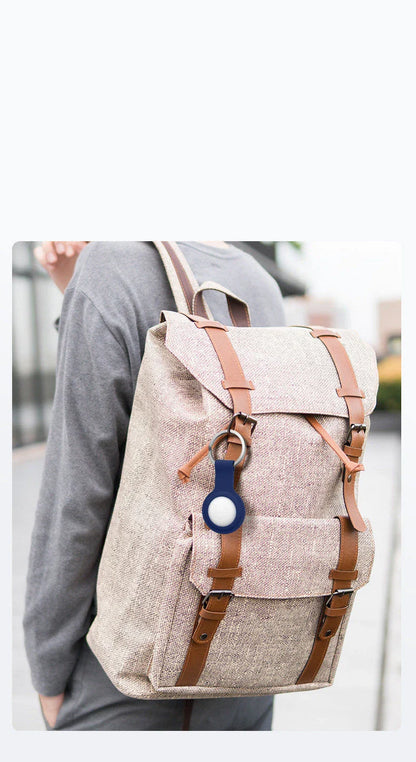 Soft, silicone AirTag holder in black and pink colors, providing protection and personalization for Apple tracking devices