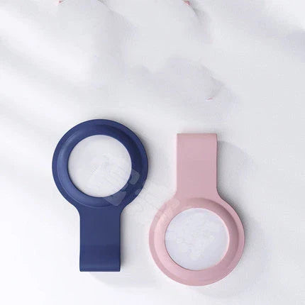 Soft, silicone AirTag holder in black and pink colors, providing protection and personalization for Apple tracking devices