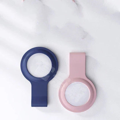 Soft, silicone AirTag holder in black and pink colors, providing protection and personalization for Apple tracking devices