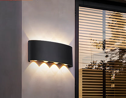 Black outdoor LED wall lamp with aluminium shell mounted on a wall, showing compact design and rainproof IP65 rating