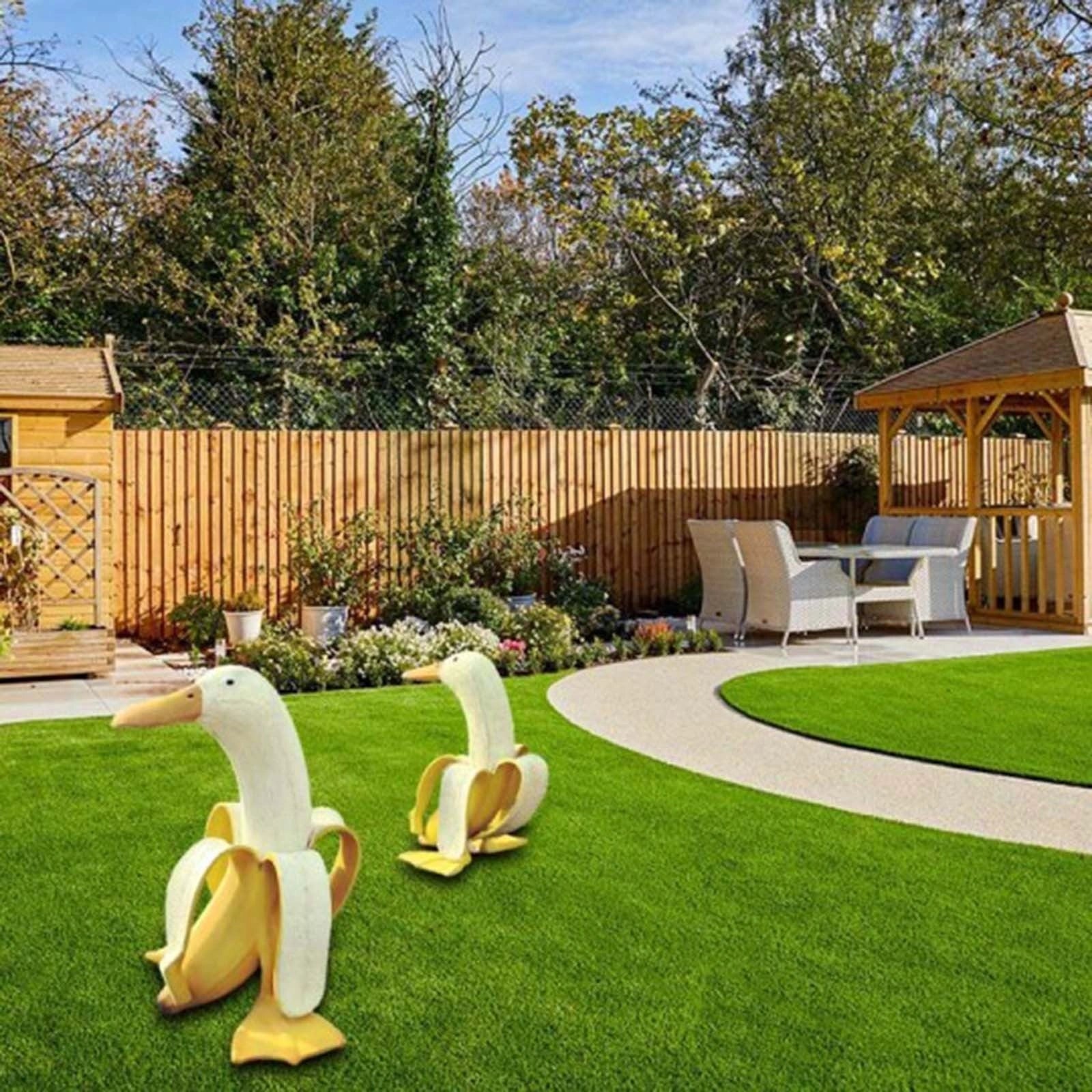 Banana Duck resin garden statue with vibrant yellow color and cartoon design