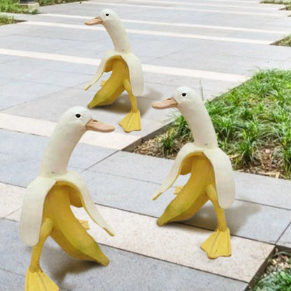 Banana Duck resin garden statue with vibrant yellow color and cartoon design