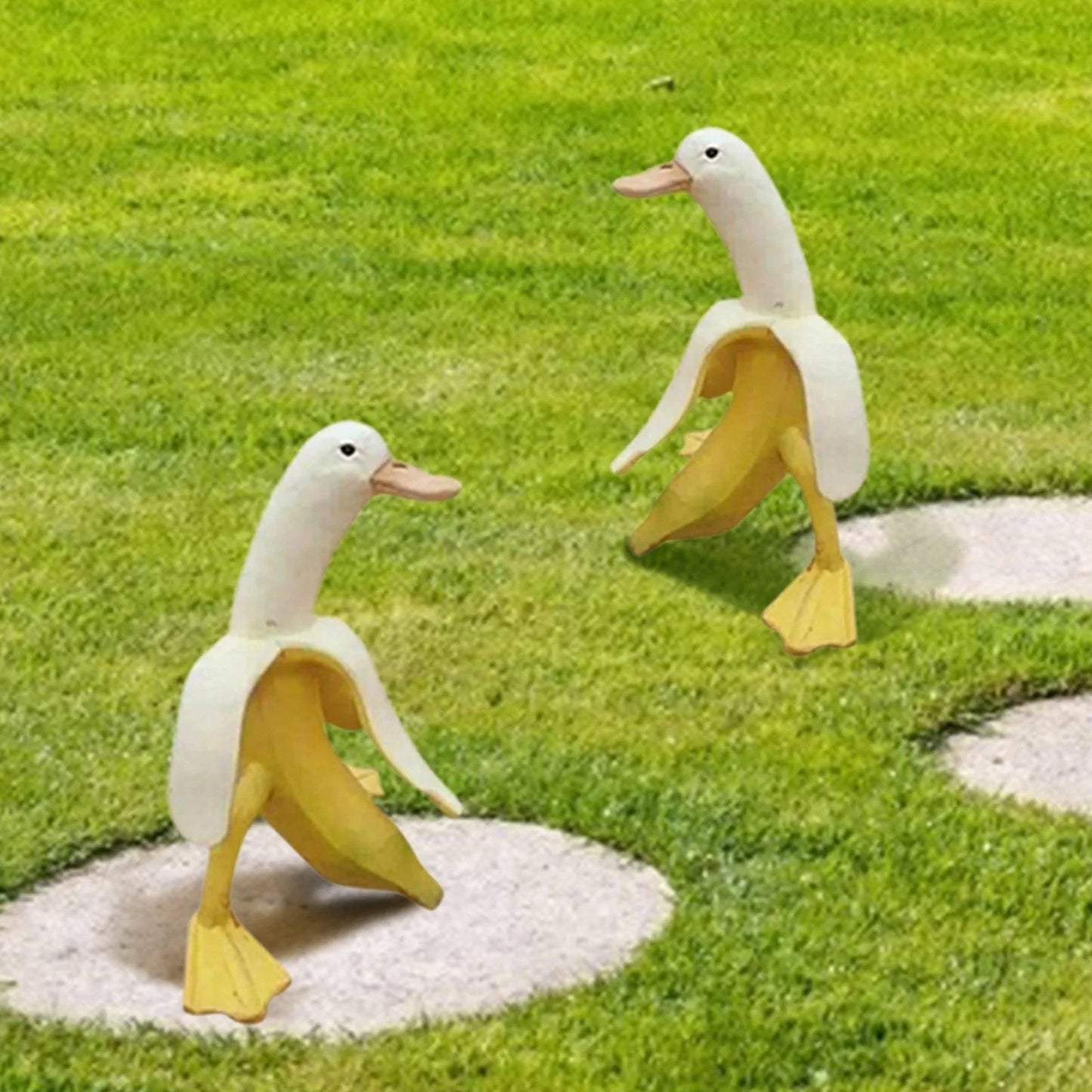 Banana Duck resin garden statue with vibrant yellow color and cartoon design