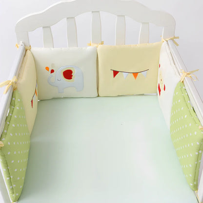 Six 30cm square cotton baby bedding panels with animal patterns surrounding white cot