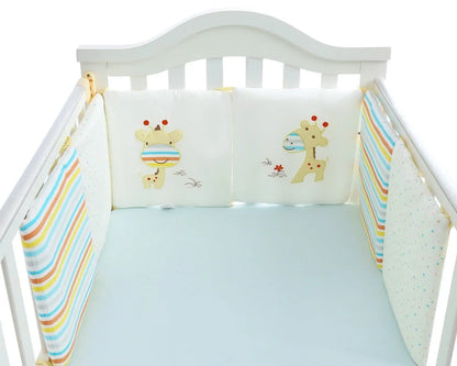 Six 30cm square cotton baby bedding panels with animal patterns surrounding white cot