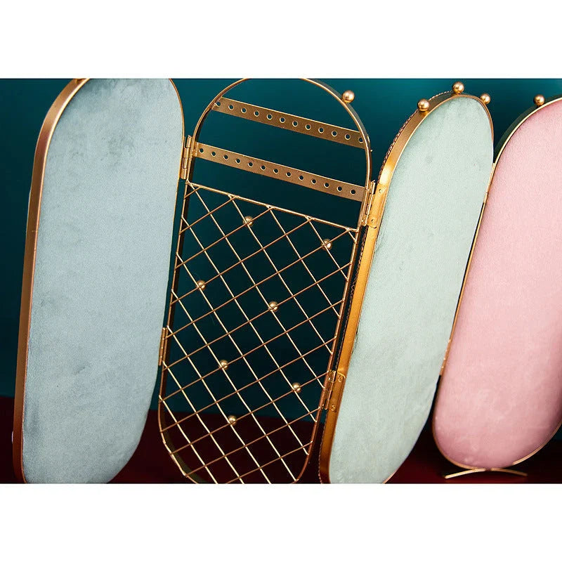 Foldable jewelry display stand with flannel-lined interior and iron frame, showcasing earrings, necklaces, and other accessories