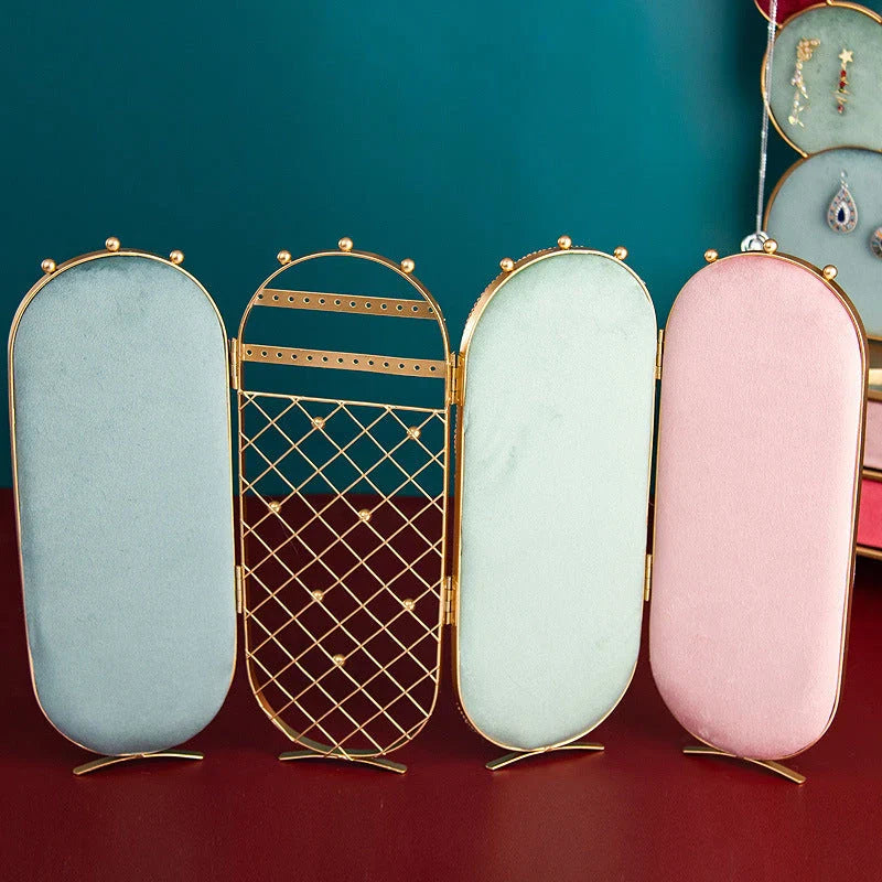 Foldable jewelry display stand with flannel-lined interior and iron frame, showcasing earrings, necklaces, and other accessories