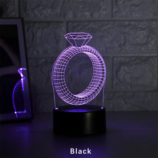 3D LED night light showing diamond ring projection with colour-changing lights on a black base