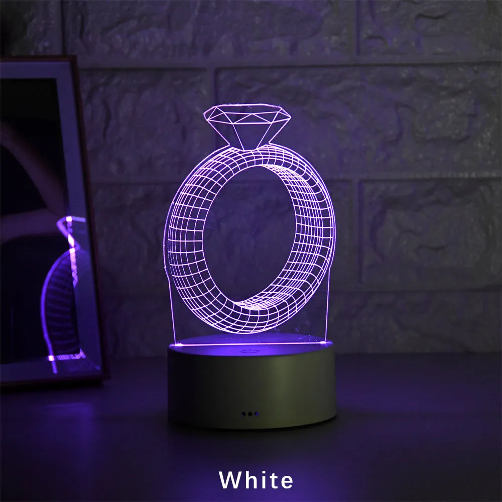 3D LED night light showing diamond ring projection with colour-changing lights on a black base