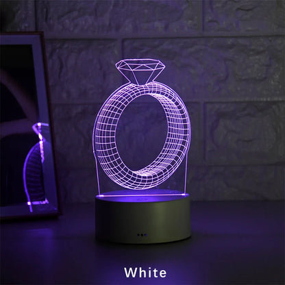 3D LED night light showing diamond ring projection with colour-changing lights on a black base