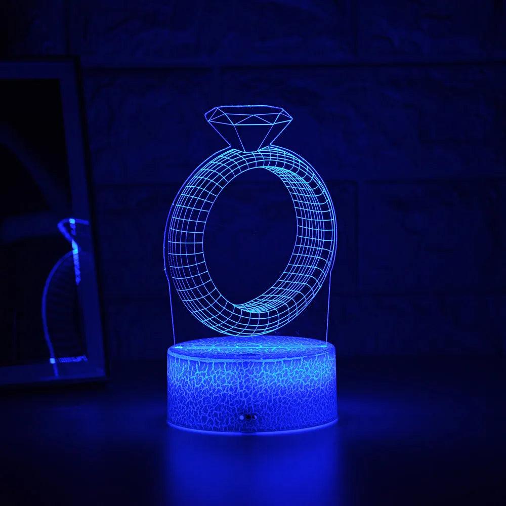 3D LED night light showing diamond ring projection with colour-changing lights on a black base