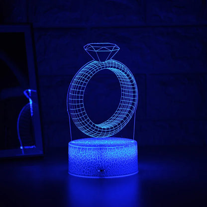 3D LED night light showing diamond ring projection with colour-changing lights on a black base