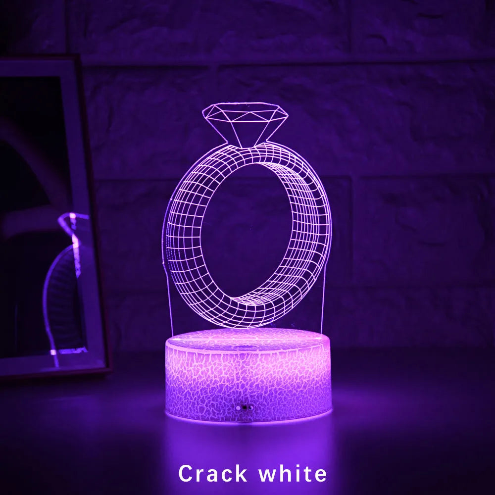 3D LED night light showing diamond ring projection with colour-changing lights on a black base
