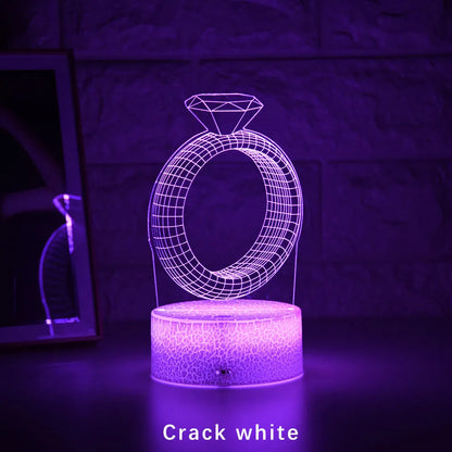 3D LED night light showing diamond ring projection with colour-changing lights on a black base