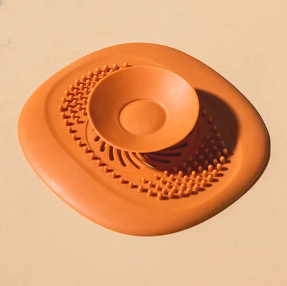 TPR vortex design sink drain cover in twilight orange, quiet blue, mango yellow, and gentian green