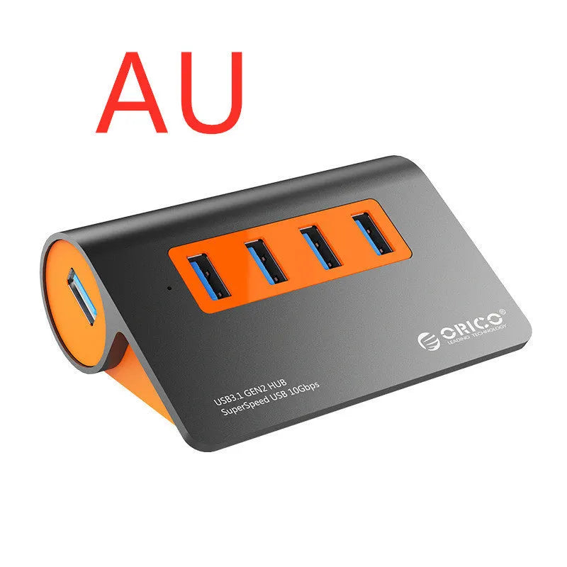 Dark grey aluminium USB-C laptop docking station with orange accents, showing USB ports, HDMI, and card readers.