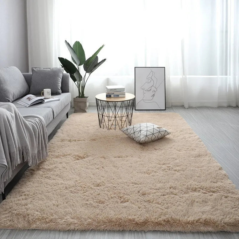 Rectangular plush carpet in solid colour with fluffy texture on hardwood floor