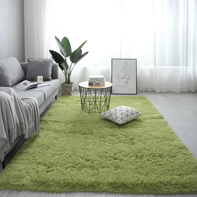 Rectangular plush carpet in solid colour with fluffy texture on hardwood floor