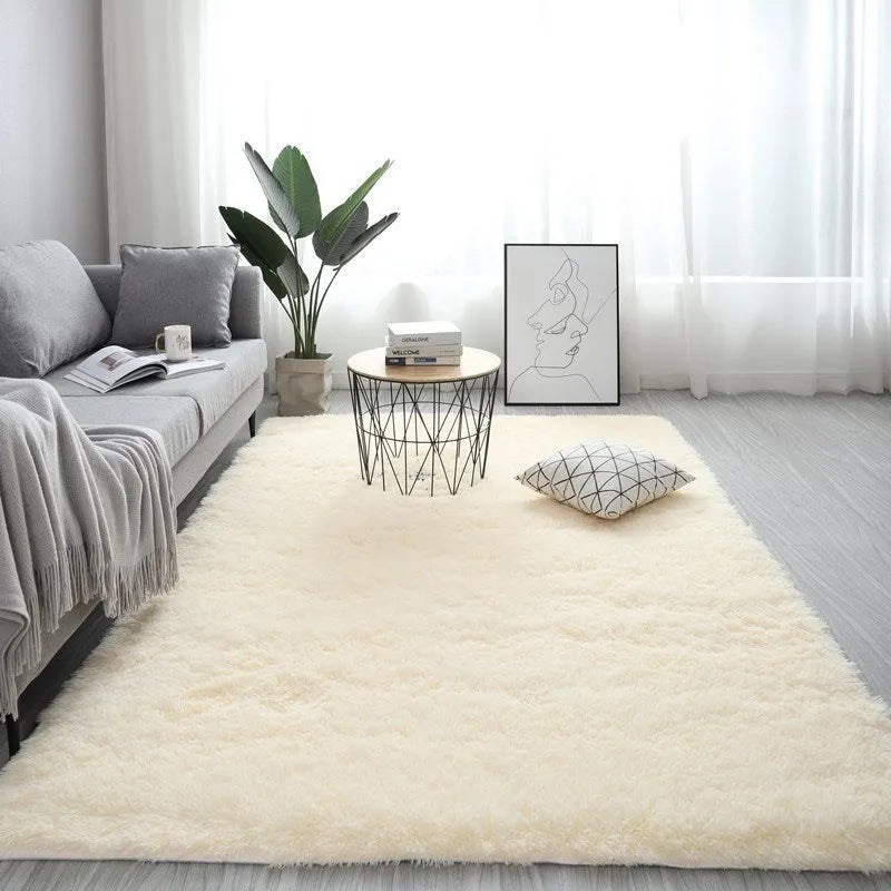 Rectangular plush carpet in solid colour with fluffy texture on hardwood floor