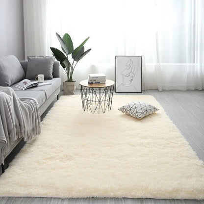 Rectangular plush carpet in solid colour with fluffy texture on hardwood floor