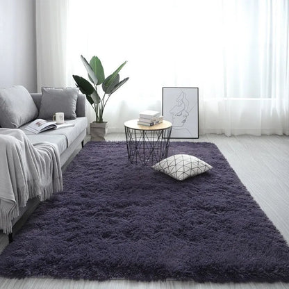 Rectangular plush carpet in solid colour with fluffy texture on hardwood floor