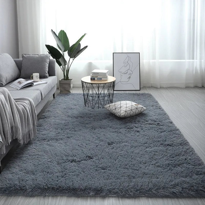 Rectangular plush carpet in solid colour with fluffy texture on hardwood floor