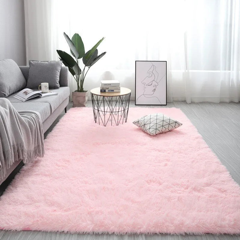 Rectangular plush carpet in solid colour with fluffy texture on hardwood floor