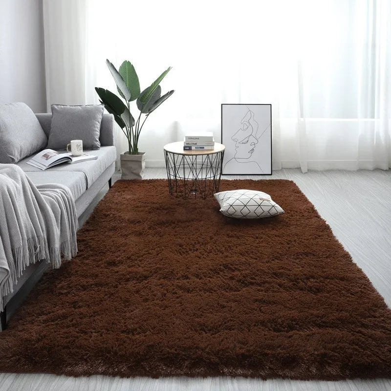 Rectangular plush carpet in solid colour with fluffy texture on hardwood floor