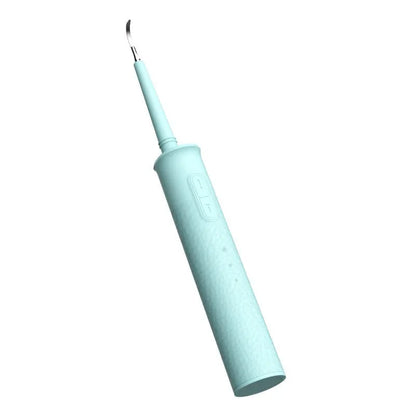 Black or green household dental scaler handle with three attachments and a charging cable on a storage tray.
