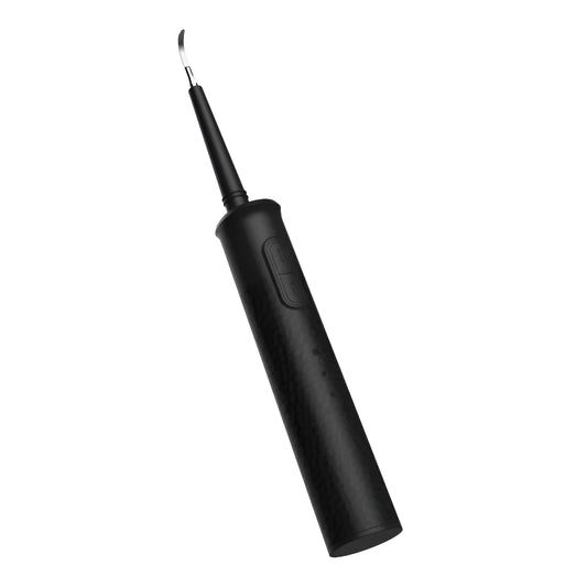 Black or green household dental scaler handle with three attachments and a charging cable on a storage tray.