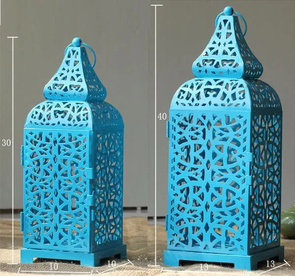 Hollow iron candlestick with geometric design measuring 38cm tall with 14cm square base