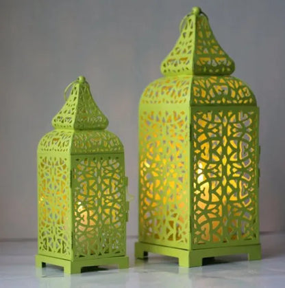 Hollow iron candlestick with geometric design measuring 38cm tall with 14cm square base