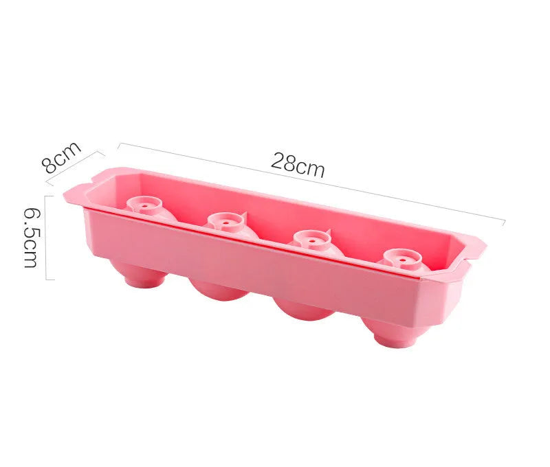 Silicone ice tray in various colours making large ice cubes, including hockey puck and geometric shapes, on a kitchen counter