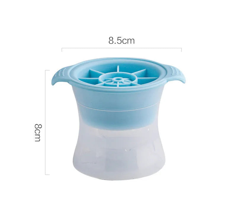 Silicone ice tray in various colours making large ice cubes, including hockey puck and geometric shapes, on a kitchen counter