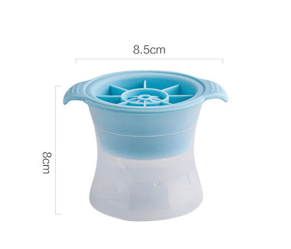 Silicone ice tray in various colours making large ice cubes, including hockey puck and geometric shapes, on a kitchen counter