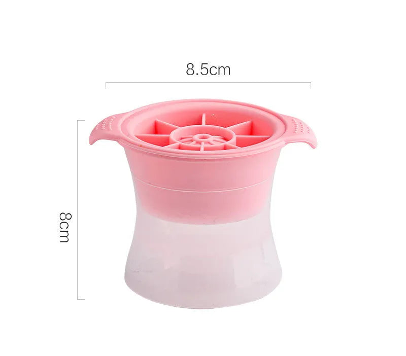 Silicone ice tray in various colours making large ice cubes, including hockey puck and geometric shapes, on a kitchen counter