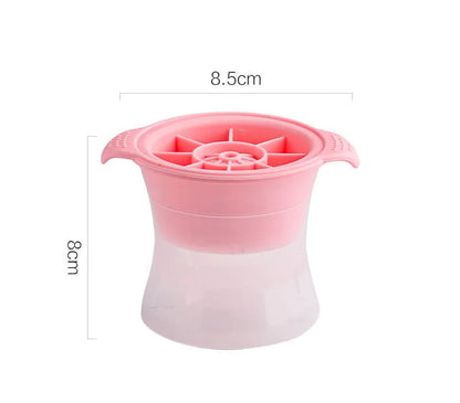 Silicone ice tray in various colours making large ice cubes, including hockey puck and geometric shapes, on a kitchen counter